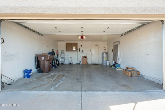 garage featuring water heater and a garage door opener