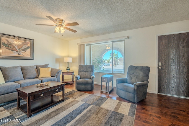 living room with hardwood / wood-style floors, a textured ceiling, and ceiling fan