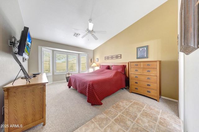 carpeted bedroom featuring vaulted ceiling, baseboards, and ceiling fan