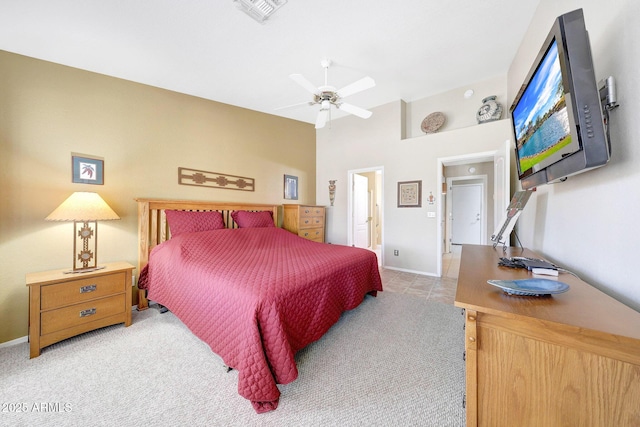 bedroom featuring light colored carpet, baseboards, and a ceiling fan