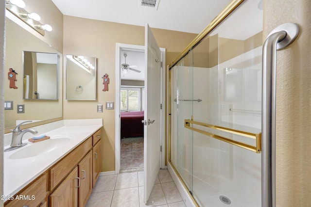 ensuite bathroom with vanity, a stall shower, tile patterned floors, and a ceiling fan