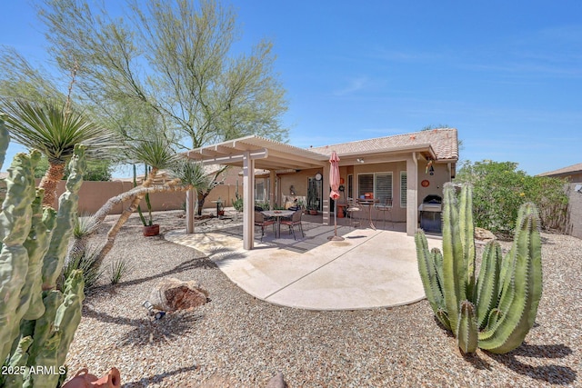 rear view of house with stucco siding, a pergola, a fenced backyard, and a patio area
