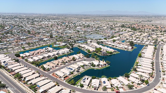 aerial view of property and surrounding area with nearby suburban area and a water and mountain view