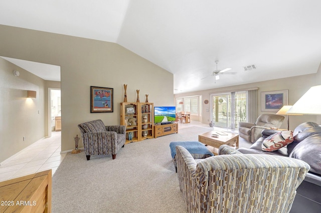 living room featuring vaulted ceiling, a ceiling fan, light colored carpet, and light tile patterned flooring