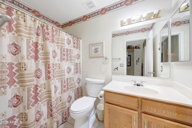 full bathroom featuring toilet, vanity, tile patterned floors, and a shower with curtain