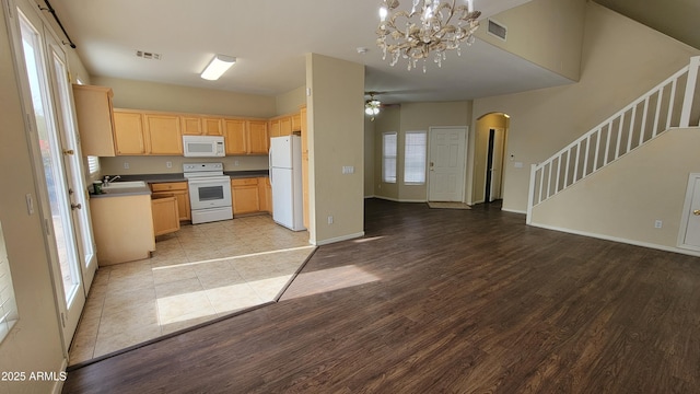 kitchen with sink, light hardwood / wood-style flooring, white appliances, and light brown cabinets