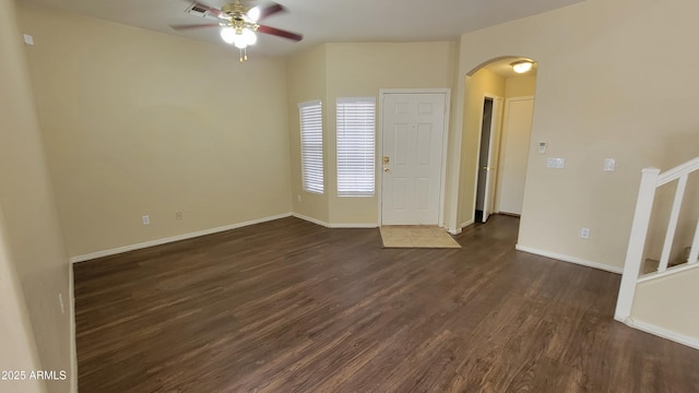 spare room featuring ceiling fan and dark wood-type flooring