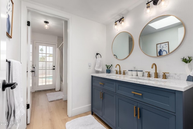6835 E Friess Dr, Scottsdale, AZ 85254 - full bath with double vanity, wood finished floors, and baseboards