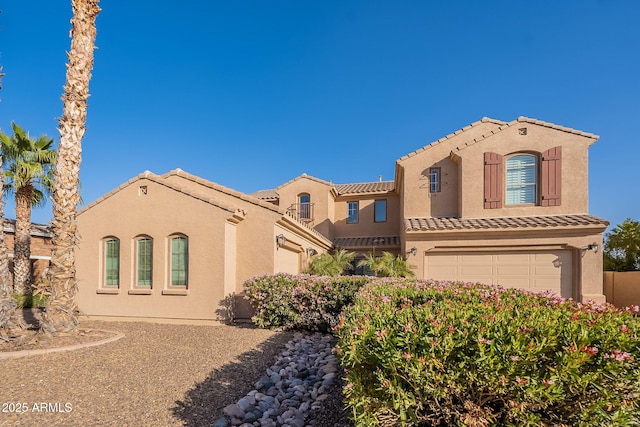 mediterranean / spanish home with a tile roof and stucco siding