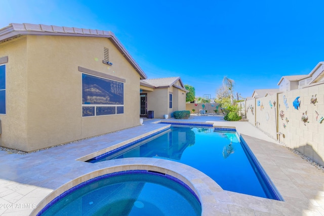 view of swimming pool featuring an in ground hot tub