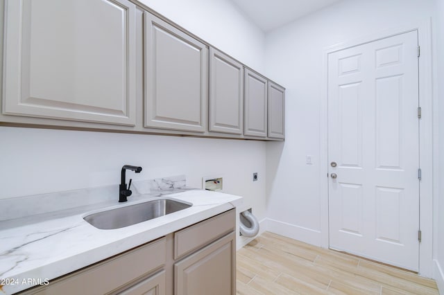 clothes washing area with cabinets, hookup for a washing machine, electric dryer hookup, and sink