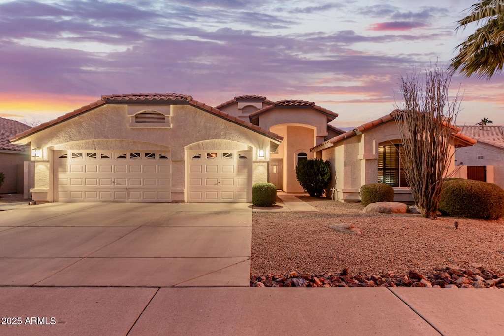 mediterranean / spanish home featuring a garage