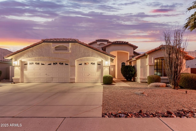 mediterranean / spanish-style home with a garage