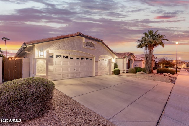 mediterranean / spanish house featuring a garage