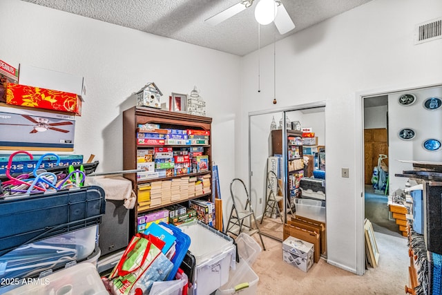 storage featuring visible vents and a ceiling fan