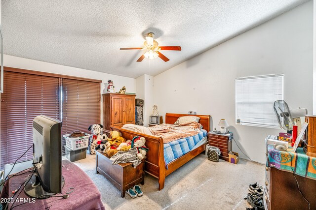 carpeted bedroom featuring a textured ceiling and a ceiling fan