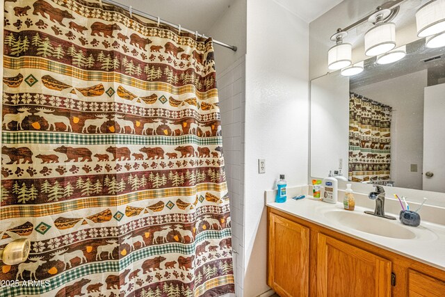 bathroom with visible vents, vanity, and a shower with curtain