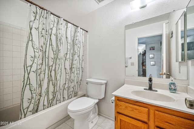 full bath featuring shower / bath combo with shower curtain, tile patterned flooring, toilet, and vanity