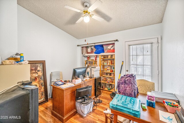 office area featuring light wood-style floors, ceiling fan, a textured ceiling, and lofted ceiling