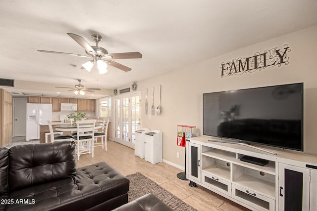 4145 W Hayward Ave, Phoenix, AZ 85051 - living area with ceiling fan, light tile patterned floors, and baseboards