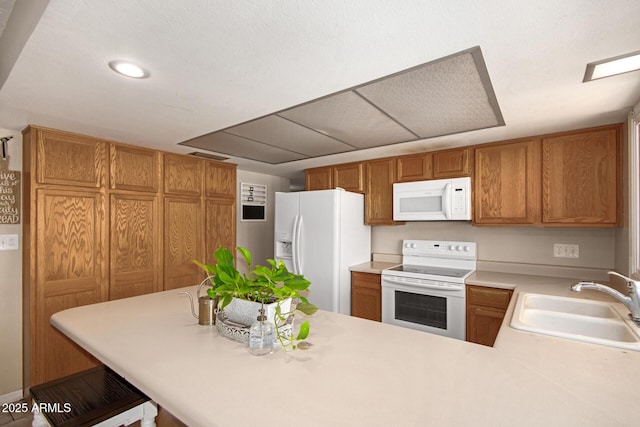 4145 W Hayward Ave, Phoenix, AZ 85051 - kitchen featuring white appliances, a sink, light countertops, a peninsula, and recessed lighting