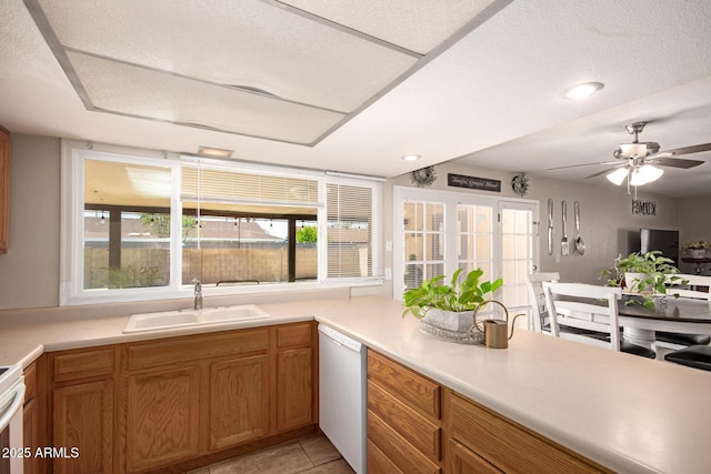 4145 W Hayward Ave, Phoenix, AZ 85051 - kitchen featuring a sink, dishwasher, light countertops, ceiling fan, and brown cabinets
