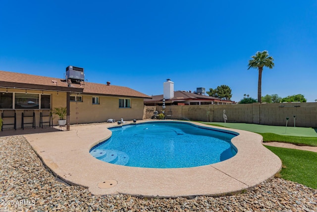 4145 W Hayward Ave, Phoenix, AZ 85051 - view of pool with a putting area, a patio area, a fenced backyard, and central air condition unit