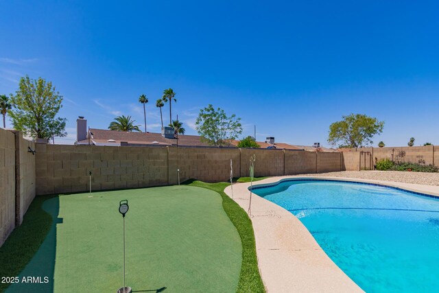 4145 W Hayward Ave, Phoenix, AZ 85051 - view of pool with an area to practice putting and a fenced backyard