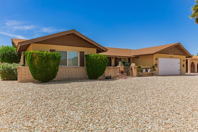 4145 W Hayward Ave, Phoenix, AZ 85051 - ranch-style house featuring a garage, driveway, and brick siding