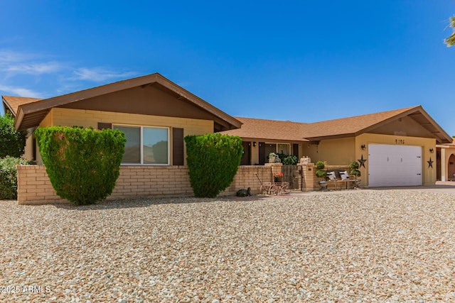 4145 W Hayward Ave, Phoenix, AZ 85051 - ranch-style house featuring an attached garage, brick siding, roof with shingles, and driveway