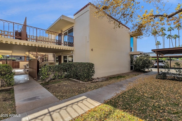 view of side of home featuring a balcony