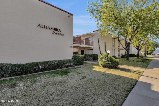 view of side of home with a lawn