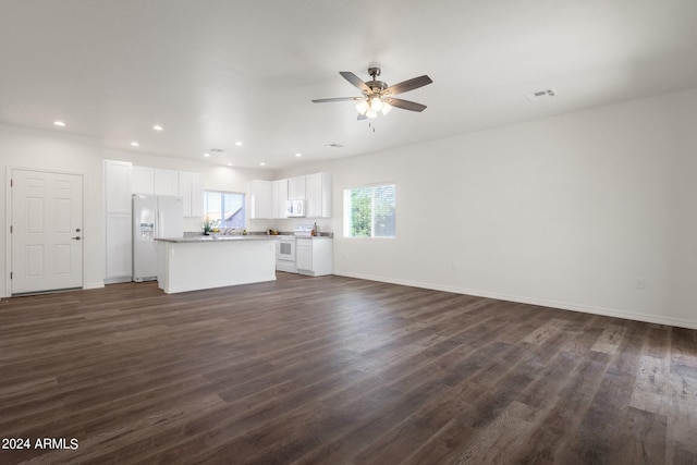 unfurnished living room with dark wood-type flooring and ceiling fan