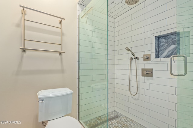 bathroom featuring walk in shower and toilet