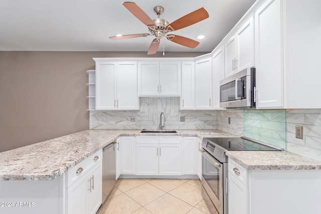 kitchen featuring stainless steel appliances, sink, ceiling fan, white cabinets, and light tile patterned flooring