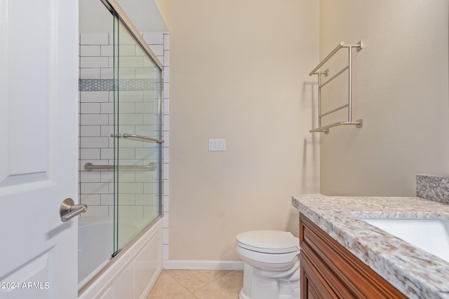 full bathroom with combined bath / shower with glass door, vanity, toilet, and tile patterned floors