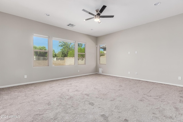 carpeted spare room featuring ceiling fan