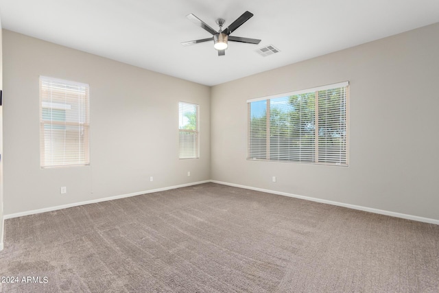 carpeted empty room featuring ceiling fan