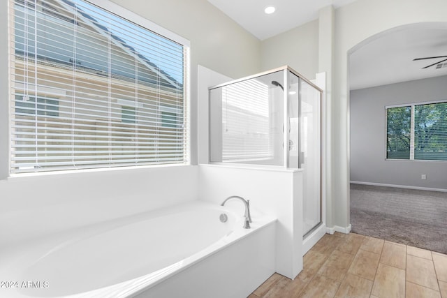 bathroom featuring separate shower and tub, a wealth of natural light, and ceiling fan