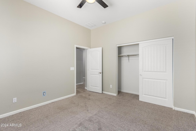 unfurnished bedroom featuring ceiling fan, light colored carpet, and a closet