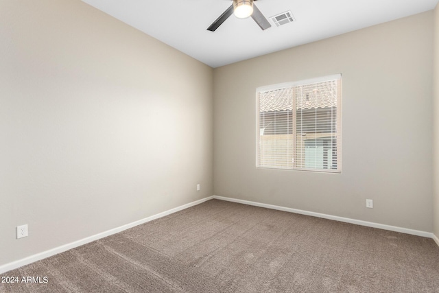 carpeted spare room with ceiling fan
