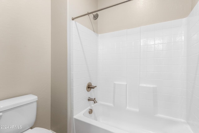 bathroom featuring shower / bathing tub combination and toilet