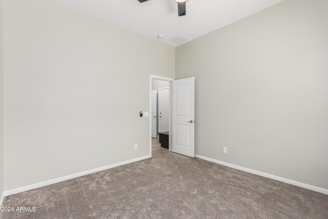 spare room featuring ceiling fan and carpet