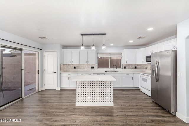 kitchen with white range with electric cooktop, stainless steel refrigerator with ice dispenser, a sink, and visible vents