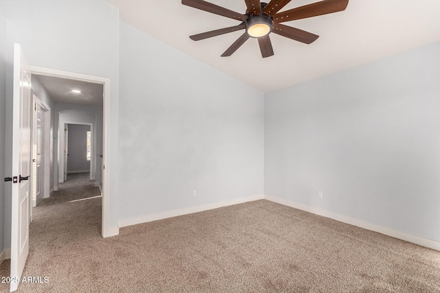 carpeted empty room featuring baseboards and a ceiling fan