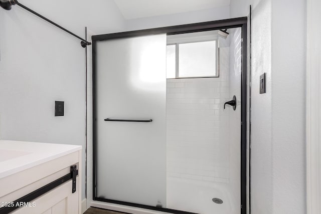 full bathroom featuring a shower stall and vanity