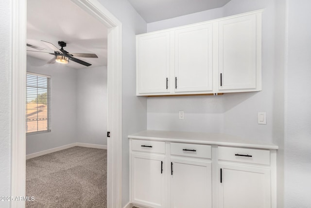 interior space with ceiling fan, carpet floors, visible vents, and baseboards