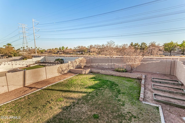 view of yard featuring a fenced backyard and a vegetable garden