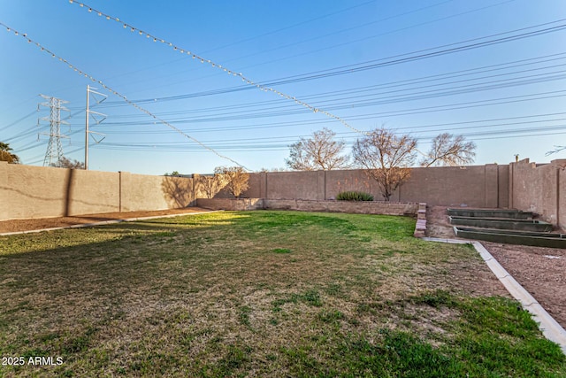 view of yard with a fenced backyard and a vegetable garden