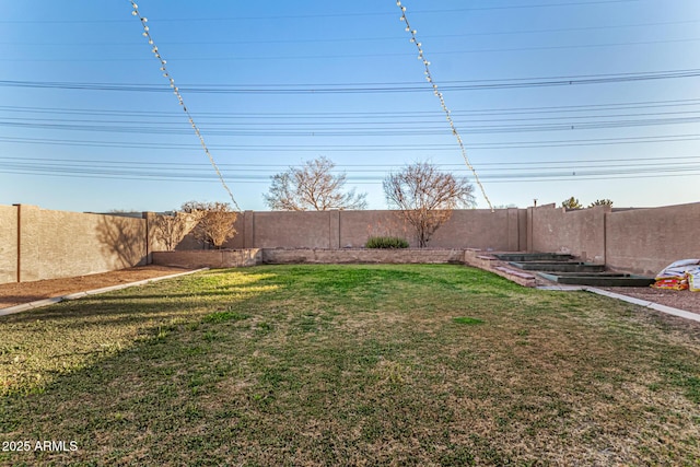 view of yard featuring a garden and a fenced backyard